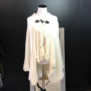 Cream acrylic ruffled cape with front toggle clasp